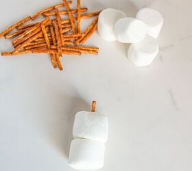 cute and easy marshmallow snowmen for the holidays, Two marshmallows stacked together with a pretzel stick inserted vertically through the center