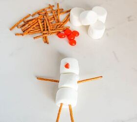 cute and easy marshmallow snowmen for the holidays, A red jelly bean added as the snowman s nose