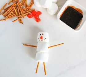 cute and easy marshmallow snowmen for the holidays, Completed marshmallow snowman with chocolate eyes and buttons red nose and pretzel arms and legs