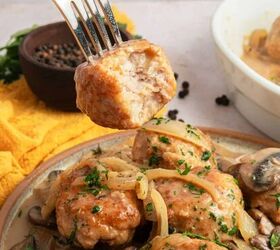 chicken marsala meatballs gf one pan, A fork holds a bite of Chicken Marsala Meatballs topped with sauce above a plate of gluten free meatballs garnished with herbs and onions with mushrooms on the side A yellow cloth and a bowl of peppercorns are in the background
