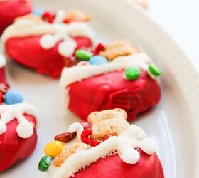 easy christmas oreos santa s toy bag oreos recipe, Low angle view of Christmas Oreo cookies topped with mini candies and teddy grahams on a white serving dish