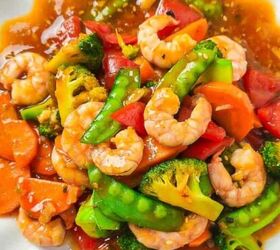 easy christmas oreos santa s toy bag oreos recipe, A colorful shrimp stir fry served on a white scalloped plate featuring plump shrimp bright broccoli florets snow peas carrots and red bell peppers coated in a glossy savory sauce