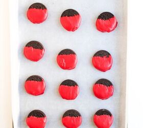 easy christmas oreos santa s toy bag oreos recipe, A baking sheet lined with parchment paper holding rows of cookies dipped in red candy coating