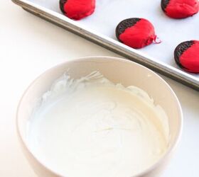 easy christmas oreos santa s toy bag oreos recipe, A bowl of smooth melted white chocolate candy coating with red dipped cookies on a tray in the background