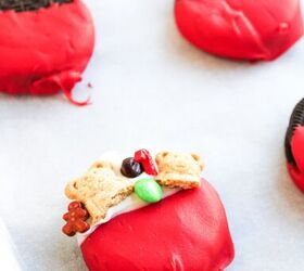 easy christmas oreos santa s toy bag oreos recipe, A red and white dipped cookie topped with mini teddy bear crackers candy pieces and festive decorations