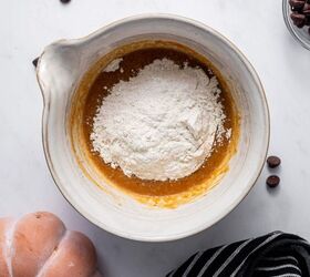 easy pumpkin mug cake recipe with chocolate chips, Flour being added to the pumpkin wet mixture