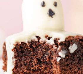 halloween brownies easy ghost brownies, A square brownie with a melted marshmallow ghost on top drizzled with chocolate and candy eyes for a spooky Halloween look a bite taken