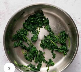 easy chicken roulade recipe with spinach sundried tomatoes gf, Sauteed spinach leaves in a stainless steel pan on a light colored countertop perfect for pairing with chicken roulade A white circle with the number 2 appears in the bottom left corner of the image