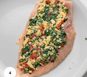 easy chicken roulade recipe with spinach sundried tomatoes gf, A raw chicken breast fillet for Chicken Roulade is topped with chopped spinach sundried tomatoes grated cheese and herbs on a white plate A white circle with the number 4 is in the corner