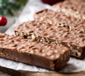homemade crunch bar recipe easy copycat crunch candy, Homemade Crunch Bars on a rustic table with parchment paper