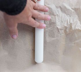 christmas crack date bark refined sugar free gluten free dairy free, hand using rolling pin to flatten Medjool dates inbetween parchment paper to make Christmas Crack Date Bark