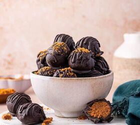 biscoff truffles recipe easy no bake cookie truffles, No bake Biscoff truffles on a white bowl coated in dark chocolate and drizzled with melted chocolate for a festive look