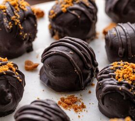 biscoff truffles recipe easy no bake cookie truffles, Close up of creamy Biscoff truffles coated in glossy dark chocolate sprinkled with crushed Lotus Biscoff cookies on top decorated beautifully