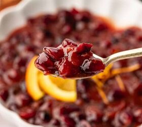 cranberry sauce from dried cranberries easy holiday recipe, Sweet and tangy cranberry sauce with a smooth texture in a spoon garnished with fresh herbs on a holiday table