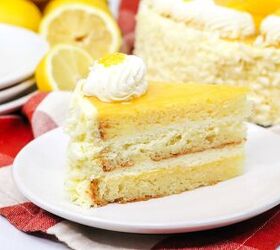 lemon curd cake, a slice of lemon cake with cream cheese frosting and lemon curd garnished with lemon slices