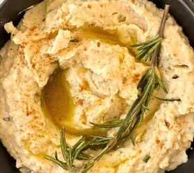 cranberry brie puff pastry bites gluten free, White Bean Dip With roasted garlic and rosemary in a black bowl with a sprig of rosemary on top
