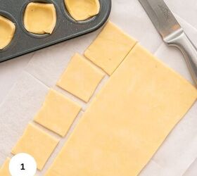 cranberry brie puff pastry bites gluten free, Rectangular piece of dough on parchment paper partially cut into small squares with a knife beside it Some gluten free dough squares are placed in a muffin tin above ready to become delicious Puff Pastry Bites