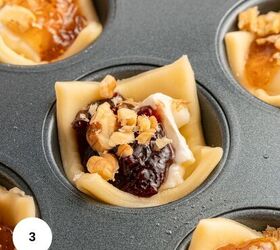 cranberry brie puff pastry bites gluten free, A close up of unbaked Puff Pastry Bites in a muffin tin filled with brie cheese berry jam and chopped walnuts One pastry cup is centered in focus with others partially visible nearby Perfect for Cranberry Brie appetizers