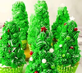easy christmas tree cupcakes to brighten holidays, Festive Christmas tree cupcakes with green buttercream frosting red star toppers and white sprinkles arranged in a group on a light surface
