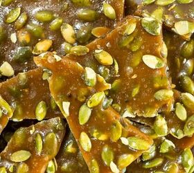 easy christmas tree cupcakes to brighten holidays, Pumpkin seed brittle pieces stacked on parchment paper showing glossy caramel coating and green pumpkin seeds