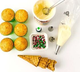 easy christmas tree cupcakes to brighten holidays, Ingredients for making Christmas tree cupcakes including vanilla cupcakes white frosting piping tips green food coloring waffle cones and holiday sprinkles arranged on a white background