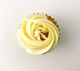 easy christmas tree cupcakes to brighten holidays, Vanilla cupcake topped with a smooth white buttercream rosette piped in a spiral pattern