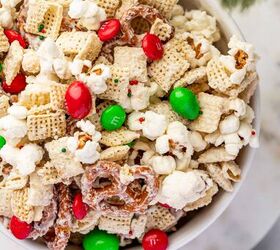 christmas crunch recipe easy holiday snack mix, Overhead shot of Christmas popcorn mix spread on white bowl with festive sprinkles and candies