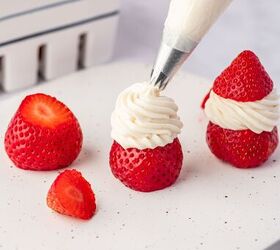 strawberry santas easy no bake christmas dessert, Hands assembling strawberry santas adding Cool Whip to create Santa s beard and frosting details