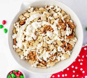 christmas crunch recipe easy holiday snack mix, Melted white chocolate being poured over the bowl with christmas crunch mix