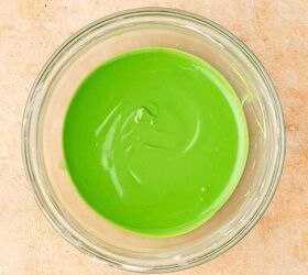 easy no bake white chocolate covered oreos 5 ingredient christmas tre, Mixing oil based green food coloring into melted white chocolate for Christmas tree drizzle