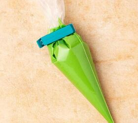 easy no bake white chocolate covered oreos 5 ingredient christmas tre, Transferring green colored melted chocolate into a piping bag for drizzling