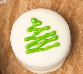 easy no bake white chocolate covered oreos 5 ingredient christmas tre, Drizzling green chocolate over white chocolate covered Oreos in a zig zag Christmas tree pattern