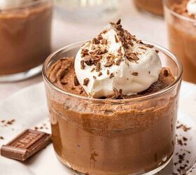 best 5 ingredient chocolate mousse to make at home, Rich and glossy chocolate mousse in large glass cups topped with whipped cream and cocoa powder