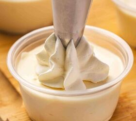 rumchata pudding shots recipe easy and festive with 5 ingredients, Piping swirls of whipped cream onto each chilled pudding shot for a neat and festive presentation