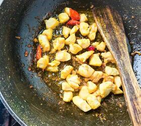 easy and delicious chicken and shrimp stir fry recipe, Browned chicken pieces saut ing with chili peppers in a wok using a wooden spatula