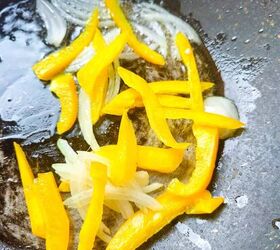 easy and delicious chicken and shrimp stir fry recipe, Sliced yellow bell pepper and onions saut ing in oil inside a wok