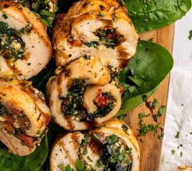 french onion pasta with gruyere cheese, Sliced chicken roulade with spinach sundried tomatoes and herbs arranged on fresh spinach leaves atop a wooden board garnished with chopped parsley and a drizzle of balsamic glaze