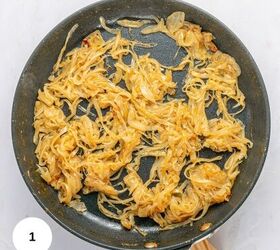 french onion pasta with gruyere cheese, A nonstick frying pan filled with golden brown caramelized onions perfect for French Onion Pasta sits on a light colored surface A white circle with the number 1 is in the lower left corner of the image