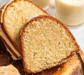 best eggnog pound cake rum eggnog glaze, A close up of a slice of bundt cake on a wooden board with two glasses of eggnog topped with a sprinkle of spice in the background