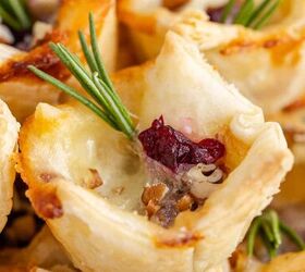cranberry brie bites, Close Up Cranberry Brie Bites Puff Pastry Stacked and Garnished with Fresh Rosemary