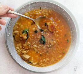 spicy tofu sausage bean soup with rice, A dish of vegan sausage bean soup with parsley A spoon is in the soup and a plate underneath