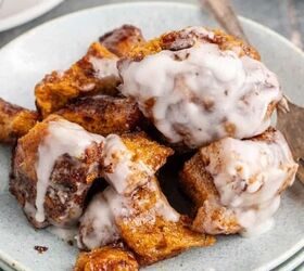 tic tac shot, Crockpot Cinnamon Bun Casserole with Icing Served on a Plate with Crockpot in Background