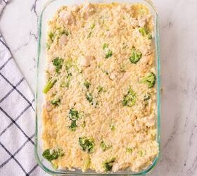 easy chicken broccoli rice casserole family favorite, Chicken broccoli rice and cream sauce fully mixed together in a casserole dish ready to bake