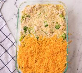 easy chicken broccoli rice casserole family favorite, hredded cheddar cheese layered over the top of cheesy chicken broccoli rice casserole before baking