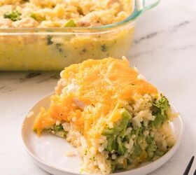 easy chicken broccoli rice casserole family favorite, Cheesy chicken broccoli rice casserole slice served on a white plate with melted cheddar on top