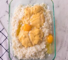 easy chicken broccoli rice casserole family favorite, Cream of chicken soup and eggs added on top of cooked rice to make creamy cheesy chicken broccoli rice casserole