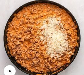 creamy italian sausage pasta with spinach, A skillet filled with creamy Italian Sausage Pasta sauce topped with a pile of freshly grated cheese on one side The sauce is rich and orange and the background is a light surface A number 4 is in a white circle at the bottom left