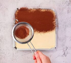 tiramisu, Fine cocoa powder being sifted over a vanilla and cocoa layer for an Italian dessert recipe