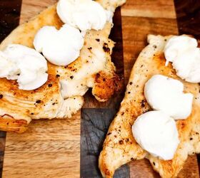 pesto chicken sandwich, cheese stuffed chicken breast on wooden cutting board