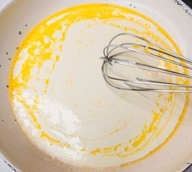 chicken alfredo bread boat, Creamy Italian sauce being whisked in a white skillet for authentic Italian cooking recipes